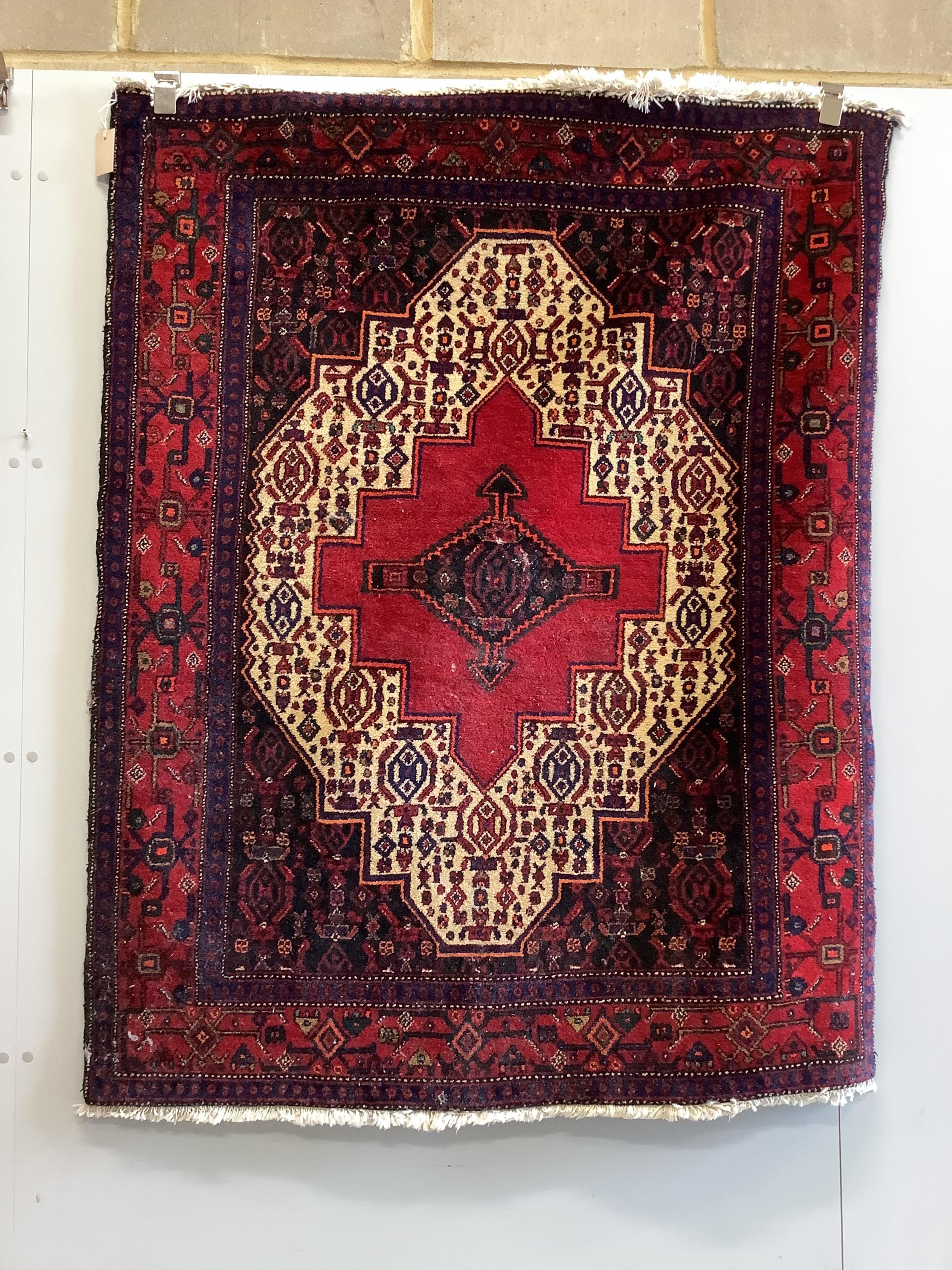 A Shiraz red ground rug, 150 x 120cm. Condition - fair